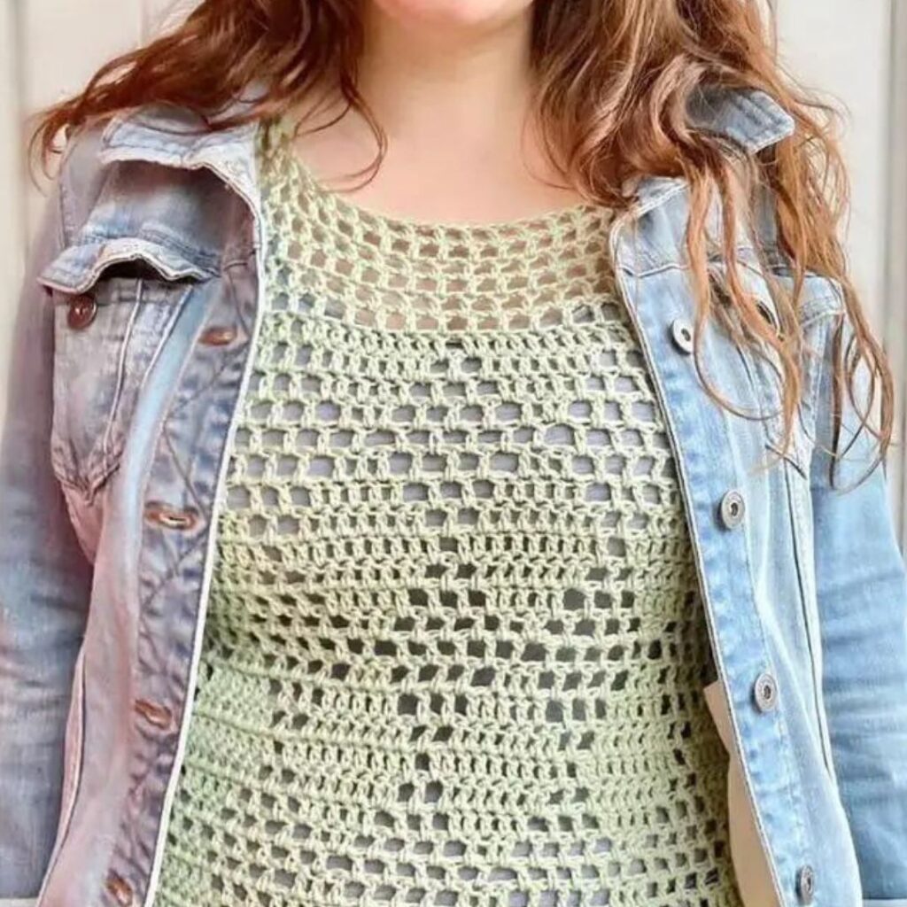 Person wearing light green crochet mesh tank top with a diamond design in the mesh pattern.