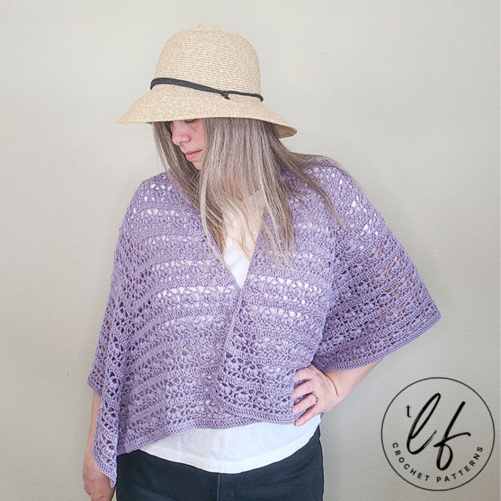 Woman wearing purple crochet lace shawl draped over her shoulders.